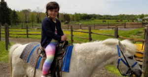 Asal ovaysi, riding a pony